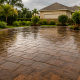 Sealed paver driveway glistening in heavy Florida rain, showing hurricane-season readiness for Pasco County homeowners