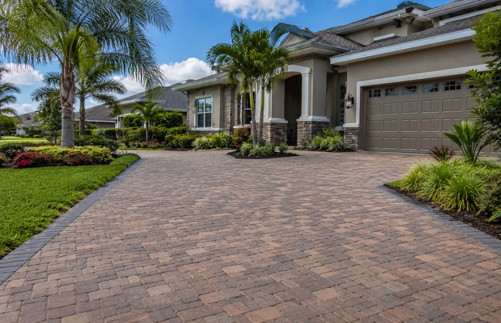 Newly installed paver driveway at a Florida home in Land O Lakes with palm trees and proper drainage slope