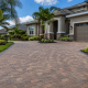Newly installed paver driveway at a Florida home in Land O Lakes with palm trees and proper drainage slope