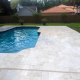 Paver pool deck with sand joint failure in Lutz FL, showing gaps needing professional stabilization before summer storms