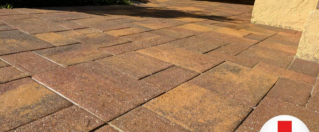 Close-up of brick paver joints with sand erosion and gaps on a Tampa Bay FL patio needing repair and resanding