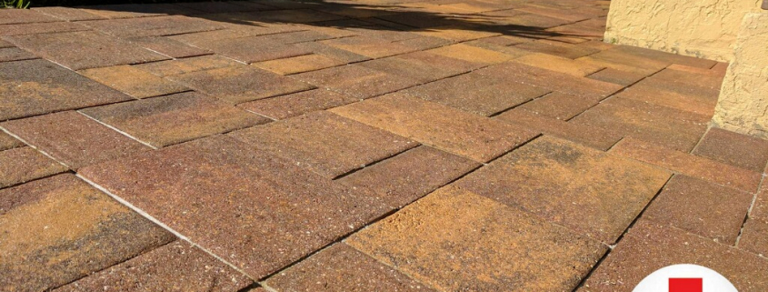 Close-up of brick paver joints with sand erosion and gaps on a Tampa Bay patio after a storm.